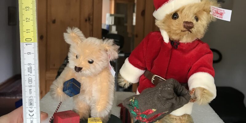 zwei kleine Teddybären, einer im Nikolauskostüm